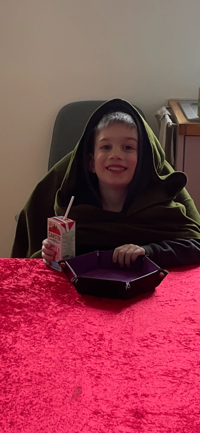 A young participant smiling in character at a tabletop session