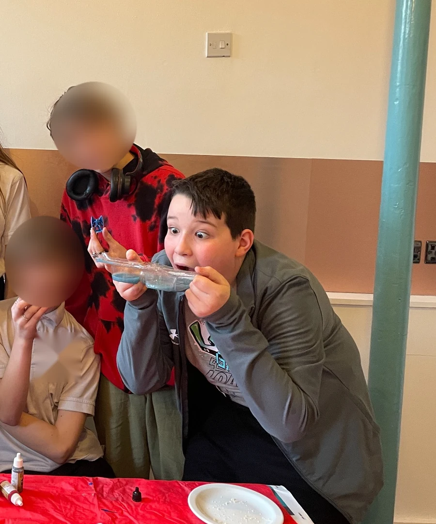 Young people taking part together in a creative Hobbyist activity; the featured participant is shown with permission while the other visible faces are tightly anonymised and school identifiers removed